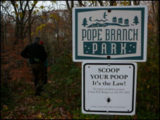 image of a Pope Branch Park sign and a scoop your poop sign