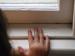 photo of child looking over window sill