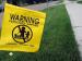 photo of grassy yard with pesticide warning flag